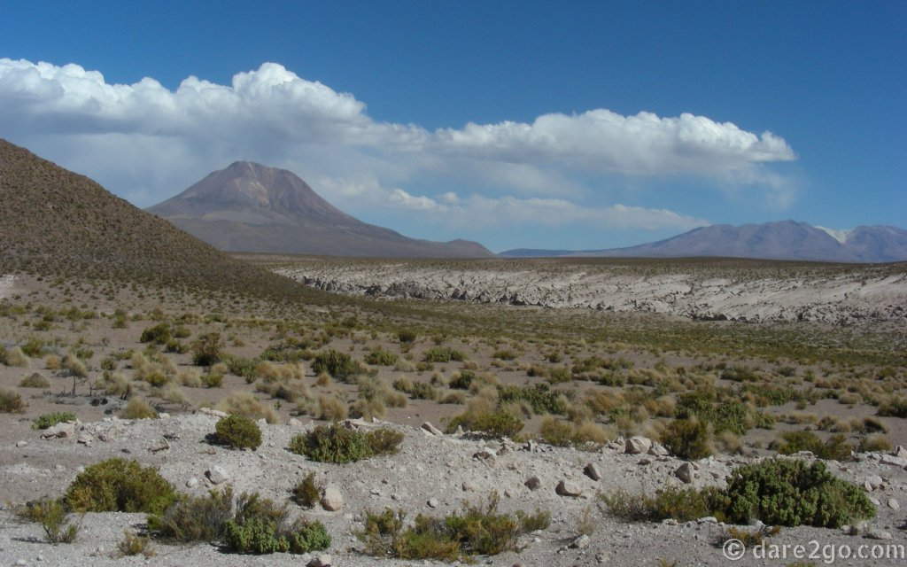 More volcanic highlands; it appears as if the mountains are forming their own clouds.