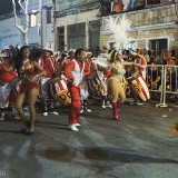 Carnival in Montevideo: another group with a grey haired El Escobillero (Broom Man) marching in front of two Vedettes and the drummers