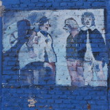 One of the murals in bad condition. Are these four men clowns?