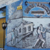 At the corner of the main square in Pan de Azucar: a tango mural with three-dimensional features. Some of the plaster has been raised for the figures (difficult to see in the photo). Another nice touch are the traditional street lights set on the curb; no tango picture is complete without those.