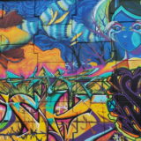 This is the fourth section from the left. Note how the fish on top is partly in one colour scheme (red orange on the left), partly in the blue colour scheme on the tail end of it (on the right).