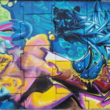 This is the fifth section from the left. If you look closely you will see that the woman's top has a fine pattern in it.