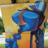 A close-up of one of the overpass street art columns