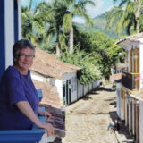 Yasha stands on the balcony of the cultural centre overlooking the cobbled streets of Paraty.