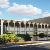 Brasilia: Palácio Itamaraty, foreign ministry, as seen from it parking lot in a side street. The water pond was designed by Roberto Burle Marx. Behind is the annex building for the main offices (the working bees).
