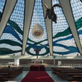 The inside of Brasilia's cathedral Nossa Senhora Aparecida, an outstanding design by architect Oscar Niemeyer, surprises! It's light and airy, simple in its lines, and has amazing acoustics. Suspended from the ceiling are three angels, created by Marianne Peretti (who also designed the stained glass).
