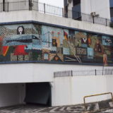 A large tile mosaic integrated into the facade of the parking levels of an apartment block in Florianopolis.