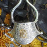 Only one example of the richly decorated gaucho accessories: a silver stirrup initialled with decorative gold lettering.