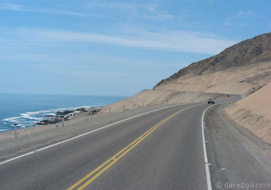 The coastal road in southern Peru: clear blue water, often steep cliffs, and inland nothing but sandy desert.