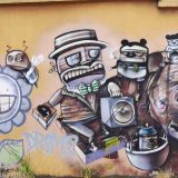 Street art in Cuenca, Ecuador: part of a long wall - expedition on a rhino.