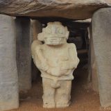 Alto de los Ídolos: this figure guards the entrance to the grave. Behind him is a stone coffin carved in a single piece.