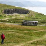 LLandudno: Yasha on the Great Orme, with the historic tram that brought her there. The Bishop's Quarry is in the background, where many interesting fossils have been found. Visitors love this bluff as much as the seaside below.