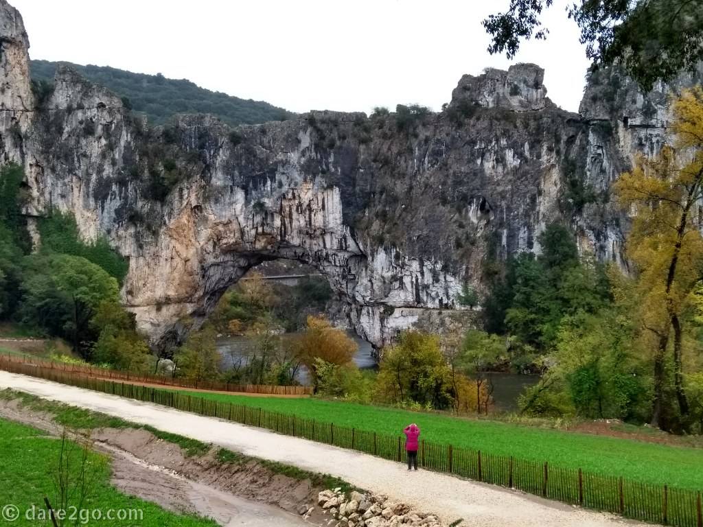 Yasha, braving the weather to take a close-up photo of the Pont d'Arc along the Ardeche.