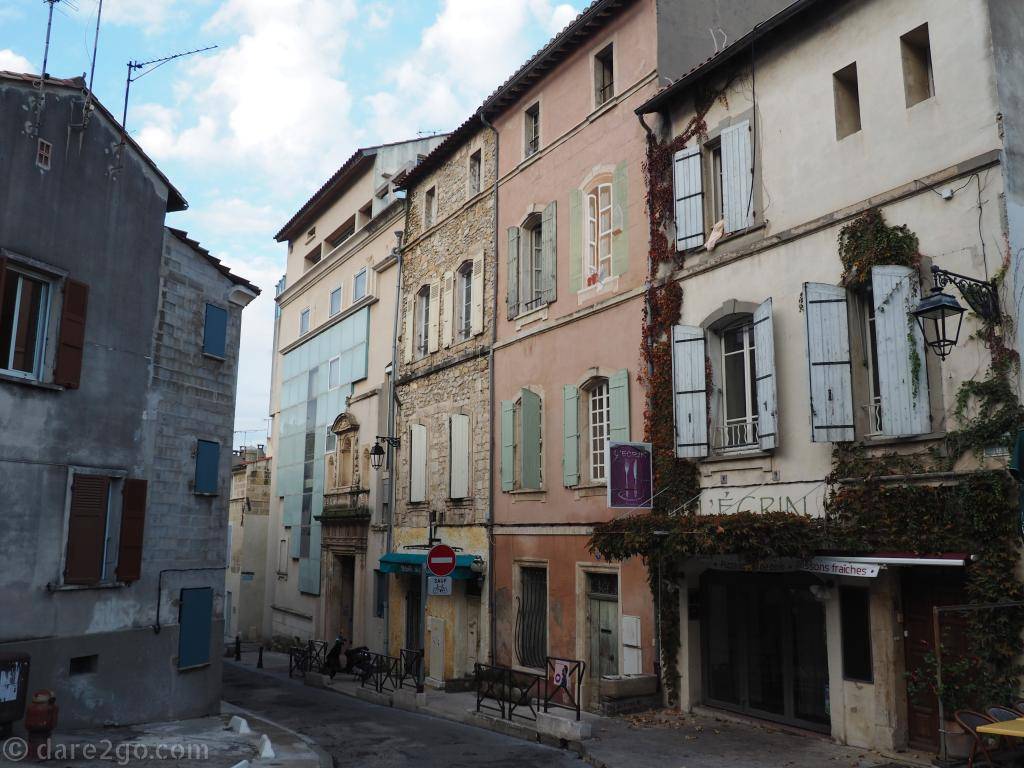 The World Heritage old town of Arles shows its history in every street, with old and new standing side by side. Notice the new building with a glass facade, incorporating an old entrance.