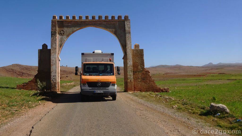 Our truck Bertita driving through an old gate in the middle of the Moroccan country side.