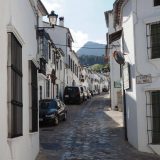 A typical street in the Pueblos Blancos of Andalusia. This one, Calle las Piedras in Grazalema, provides just enough space to drive a car along, past the row of parked cars.