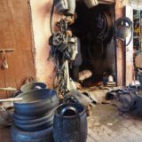 A shop recycling old tires and making bowls, buckets, and other useful items from the rubber.