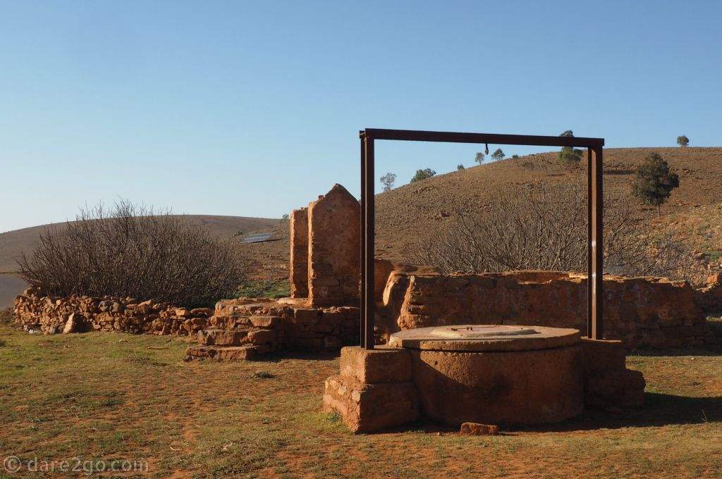 An old well, with the top closed off because it has been replaced by a solar powered pumping station.