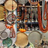 Strangely mixed items on display at a shop in Morocco: jewellery, tea pots (old & new), some antiques, and many new things.