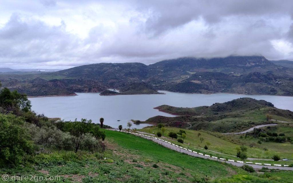 Zahara-El Gastor Reservoir, as seen from Zahara de la Sierra. It completes the picture: mountain top castle above, turquoise lake (when the sun is shining) below, and a white village flowing down the slope between.