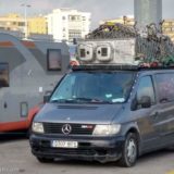 A van at port, the roofrack packed high with various things - including a kitchen sink!