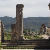 Roman columns in the foreground with the Basilica in the background.