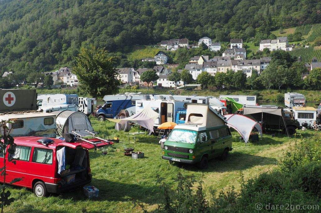 The diverse overland vehicles at the Willys Meeting: a look at part of the camping area from the entry bridge. You can see all sorts of very different expedition vehicles, from Volkswagen vans to serious expedition trucks.