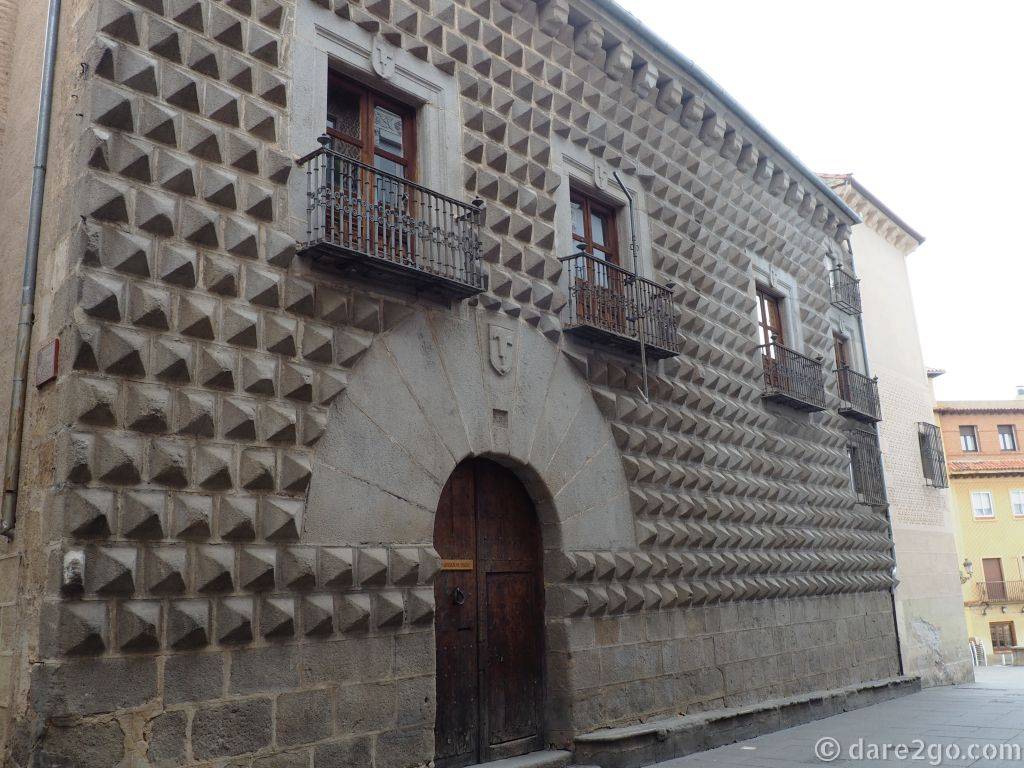 Casa de los Picos with its distinctive facade covered in granite blocks, carved into pyramid shapes.