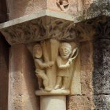 Carved detail on a doorway of a house showing a man tied to a whipping post and another man with a whip.