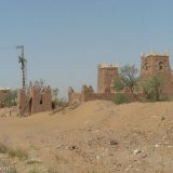 This Kasbah-style hotel is abandoned and the desert is trying to take it back. This stands on the road between M'hamid and Zagora.