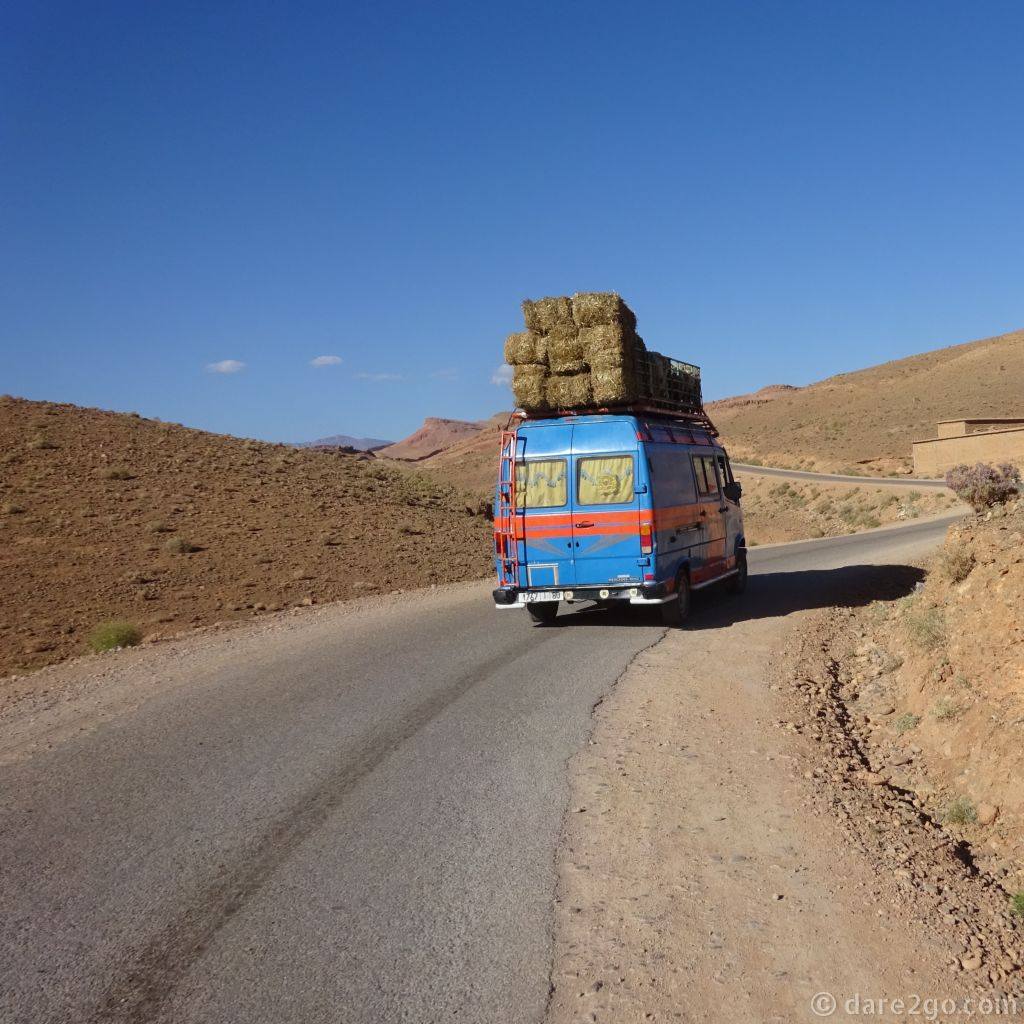 Overstacked vehicles are common in more remote areas. This typical Mercedes Bremer minibus is carrying people inside. As well as the pile of hay, there are a number of animals on the front part of the roof - mostly sheep, I think.