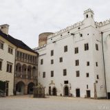 One of several large courtyards inside the Jindrichuv Hradec Chateau. In the centre is an elaborately decorated well cover.
