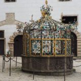 A closeup of the elaborately decorated well cover inside the Jindrichuv Hradec Castle.