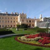 Another view of Chateau Lednice with formal gardens and the greenhouse, which is also from the 1840s, in the foreground.