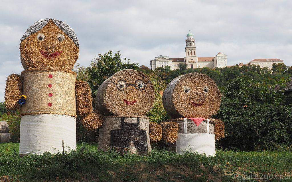 An interesting hay-bale family in the town of Pannonhalma, Hungary. In a prominent position above the town is the Archabbey Pannonhalma.