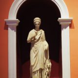 A beautifully detailed marble statue depicting Nemesis.