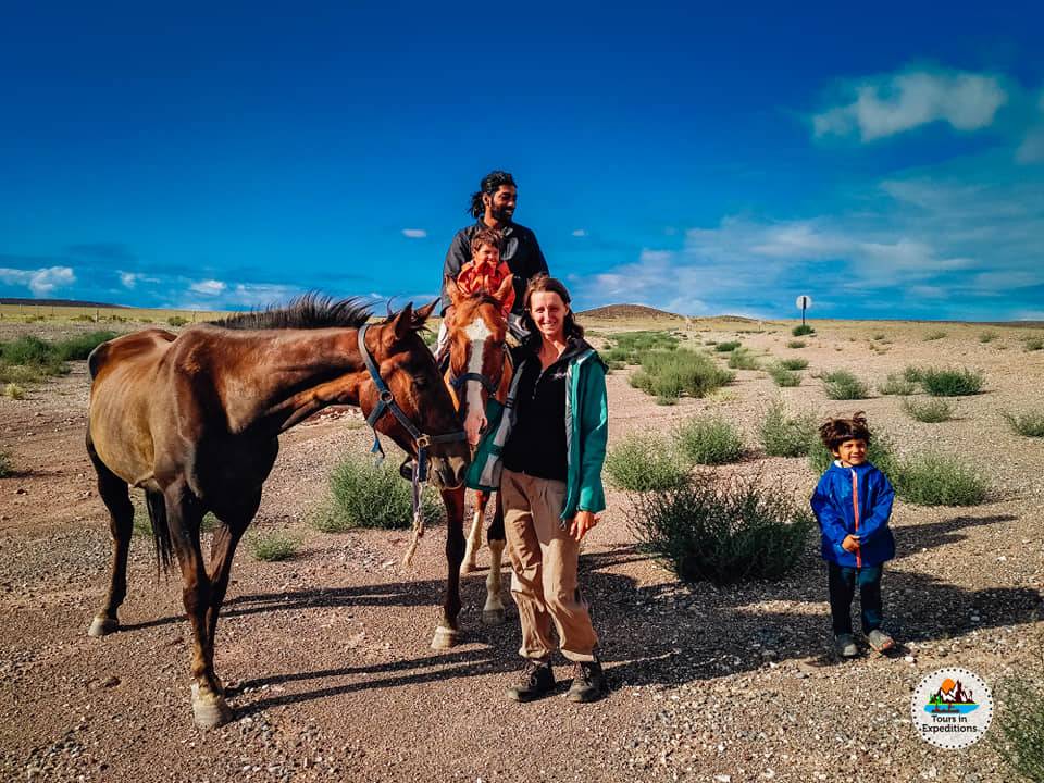 This family travels in South America on horseback with an RV as support vehicle [family on horses in landscape]