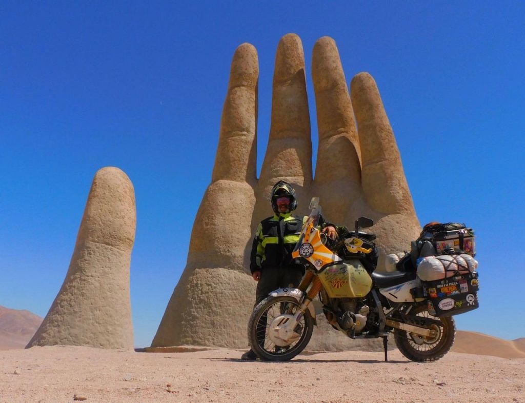 Dan with Sunny (his bike) in Chile before the pandemic stopped all travel. They're on their way to Ushuaia.