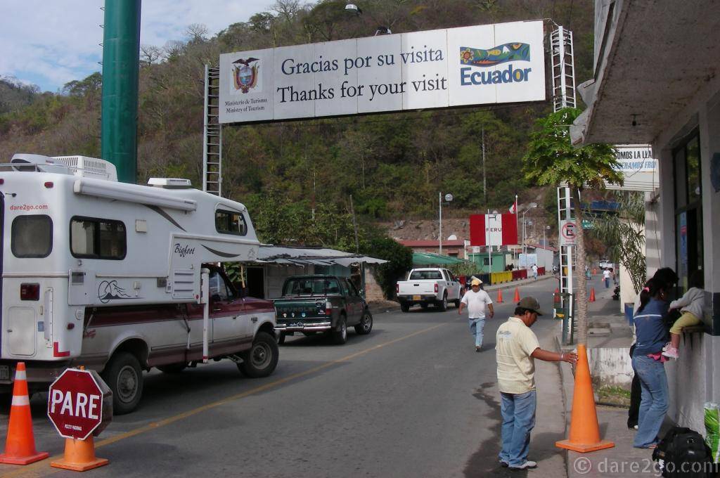 Border crossing from Ecuador into Peru. To the left, our truck camper from the first journey.
