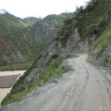 The PE 3S, the southern section of Peru's National Road Number 3, which stretches almost all the way from north to south. It's mostly sealed - except where it's not (like here), but single lane almost the entire length. In the background a semitrailer is navigating a narrow bend, with a bus blocking his way.