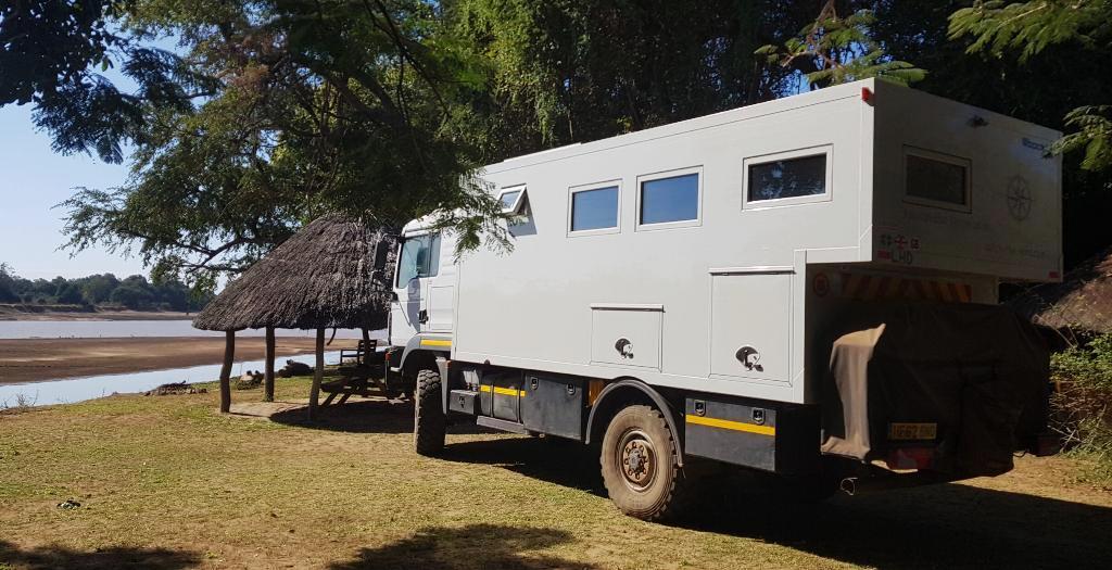 One of the few excursions to a National Park (overland truck parked near a gazebo in a park)