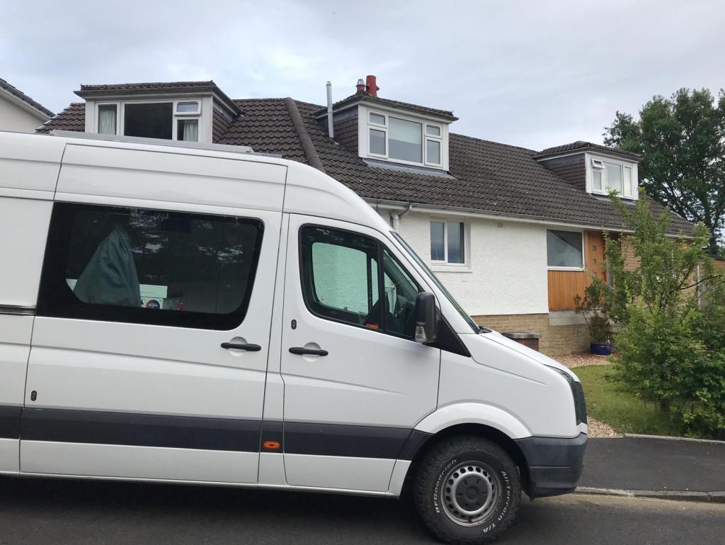 Our van arrived back in the UK (white van parked in front of a house)