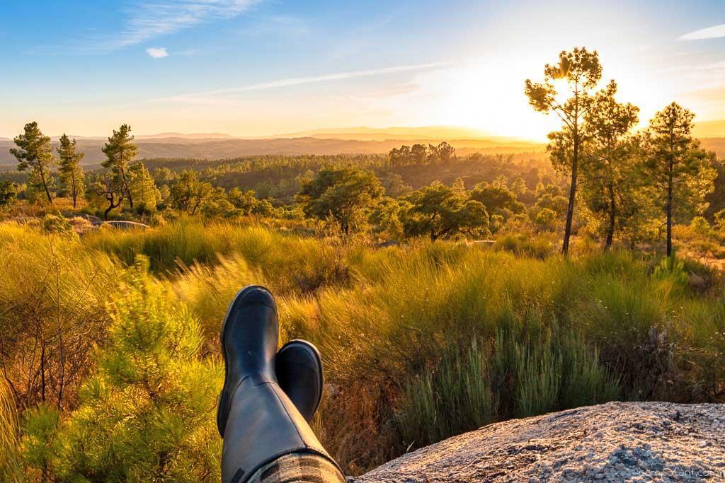 A new experience: to overlook our large block of land that we just bought (a pair of man's boots resting on a rock with landscape behind)