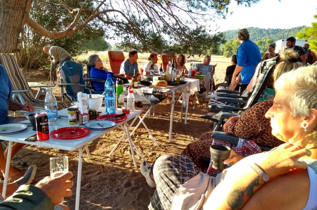 (People sitting outdoors around tables.) Get together of Europeans in Greece. All these people from Germany, France, Holland, and us had been stranded in Greece during the entire lockdown from March to July when the ferries were reinstated.