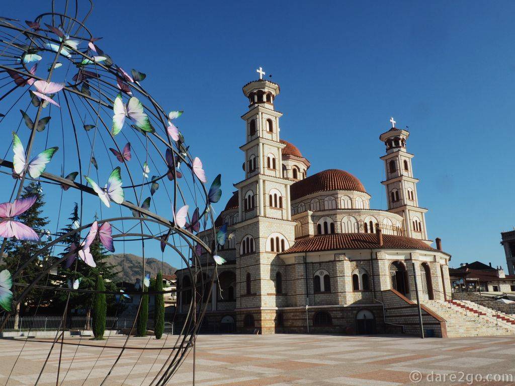 The Resurrection Cathedral with another public art piece in the foreground: a wire globe covered in colourful butterflies.
